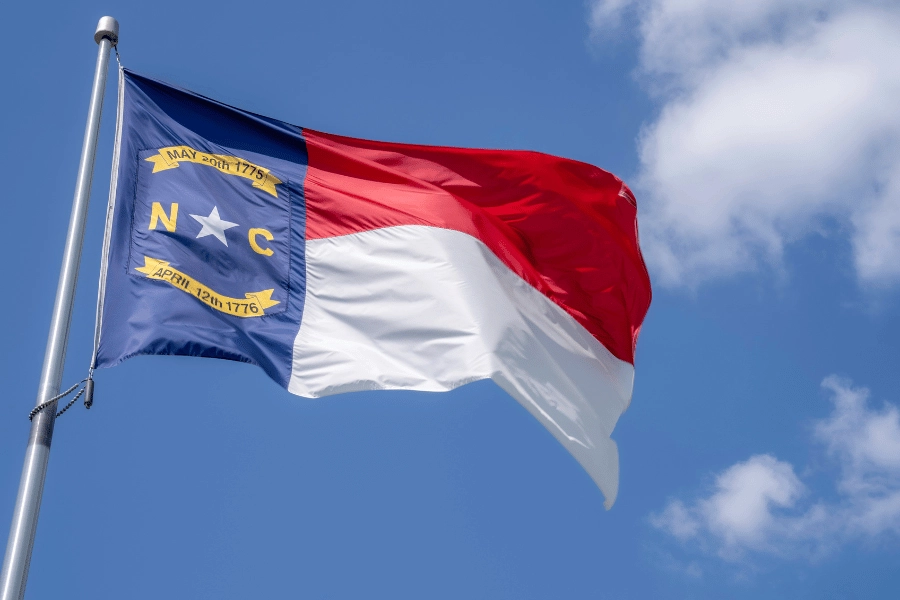 North Carolina state flag waving in the wind on a flagpole